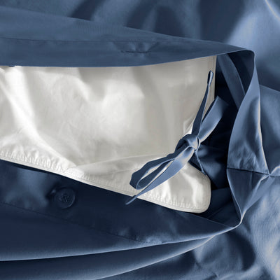 Duvet set featuring a blue exterior with a white interior and a tied closure detail.