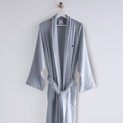 Light gray terry bath robe with long sleeves, a belt, and a hanging loop.