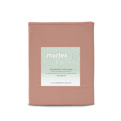 Solid twin sheet set in a muted pink color with a label detailing fabric blend and features.