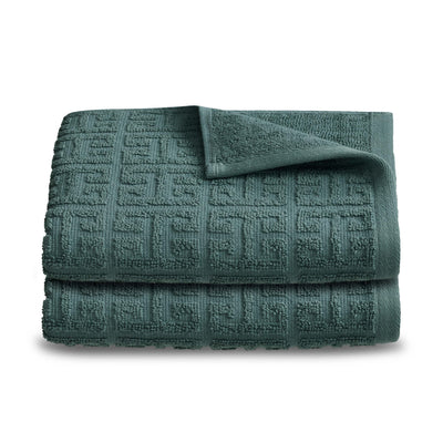 Two folded hand towels in a textured, dark green fabric with a geometric pattern.