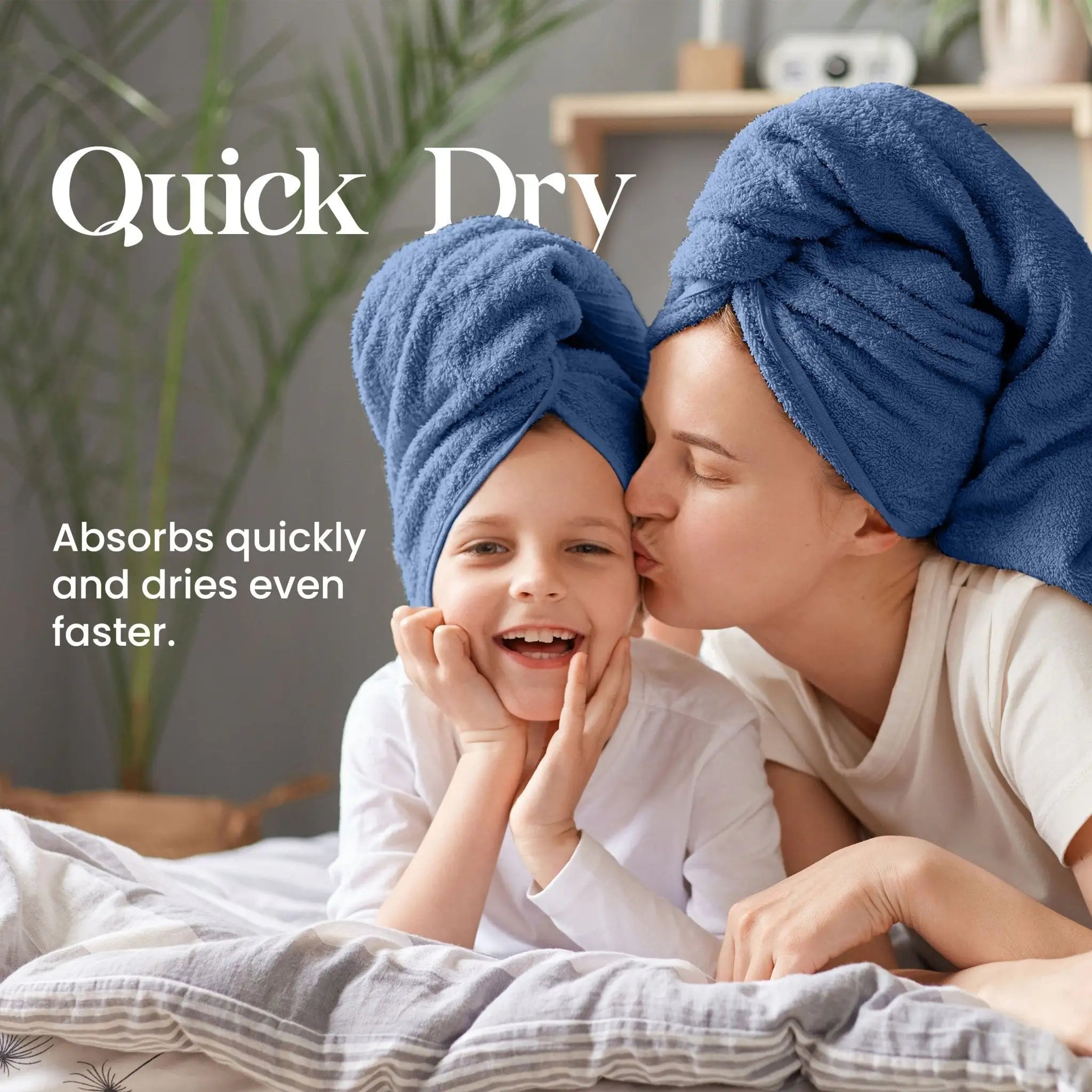 Woman and child with blue towels on heads, lying on a bed with text 'Quick Dry' and 'Absorbs quickly and dries even faster.'