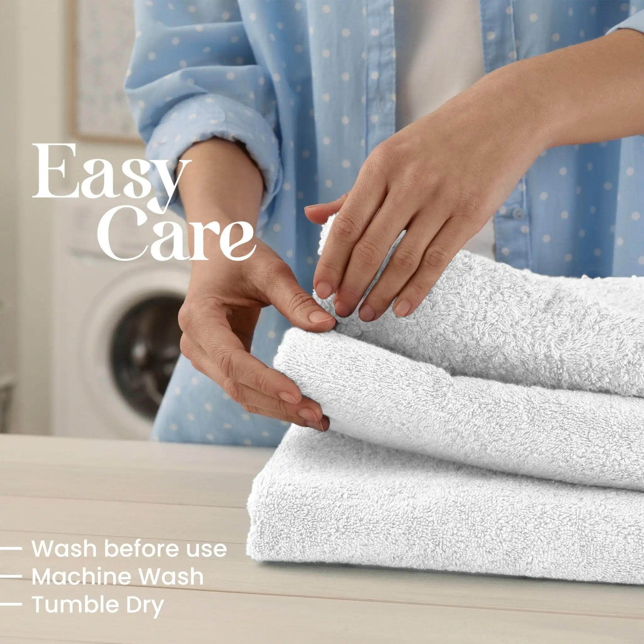 Person folding white towels with text on easy care instructions.