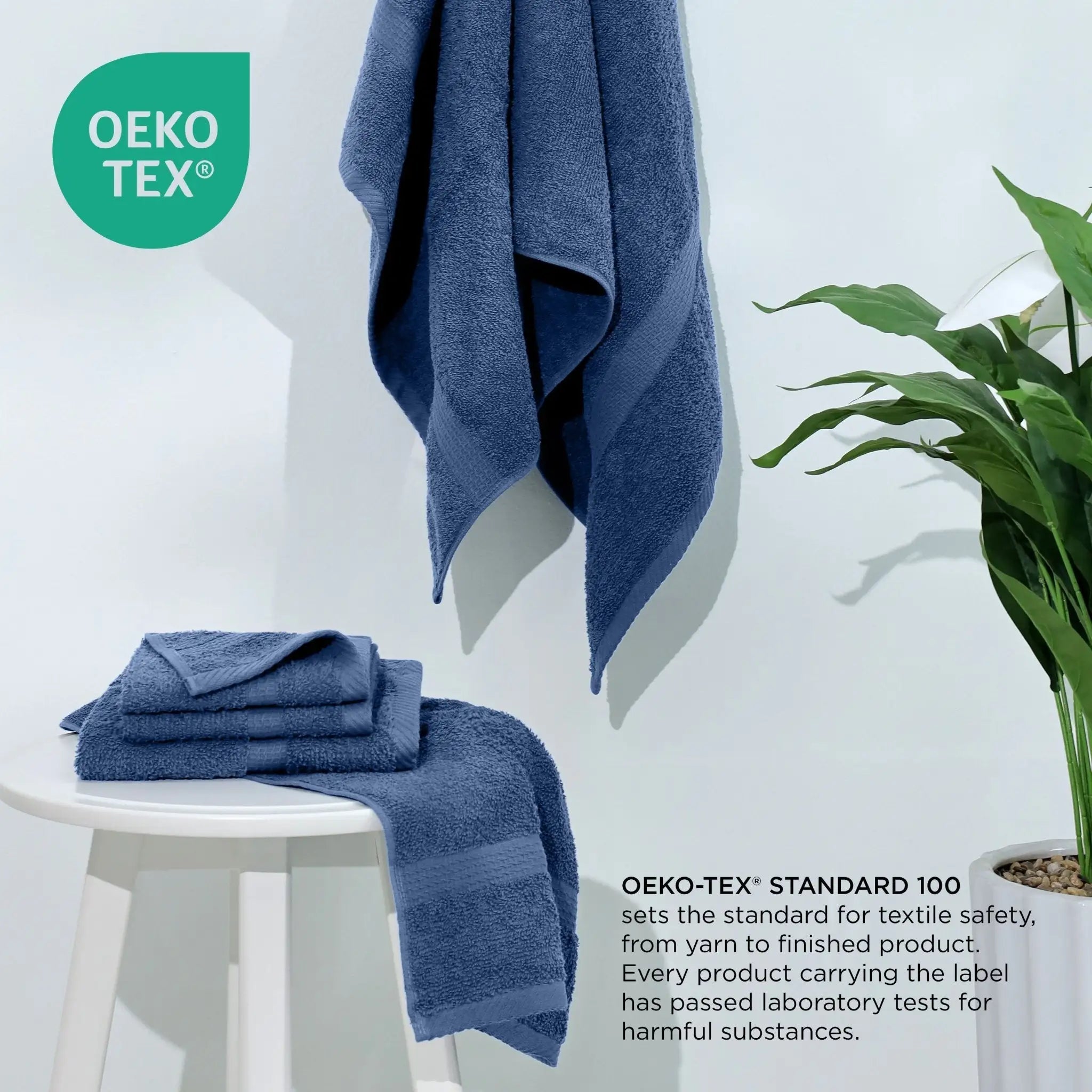 Blue towels on a white stool with a plant, featuring the Oeko-Tex logo.