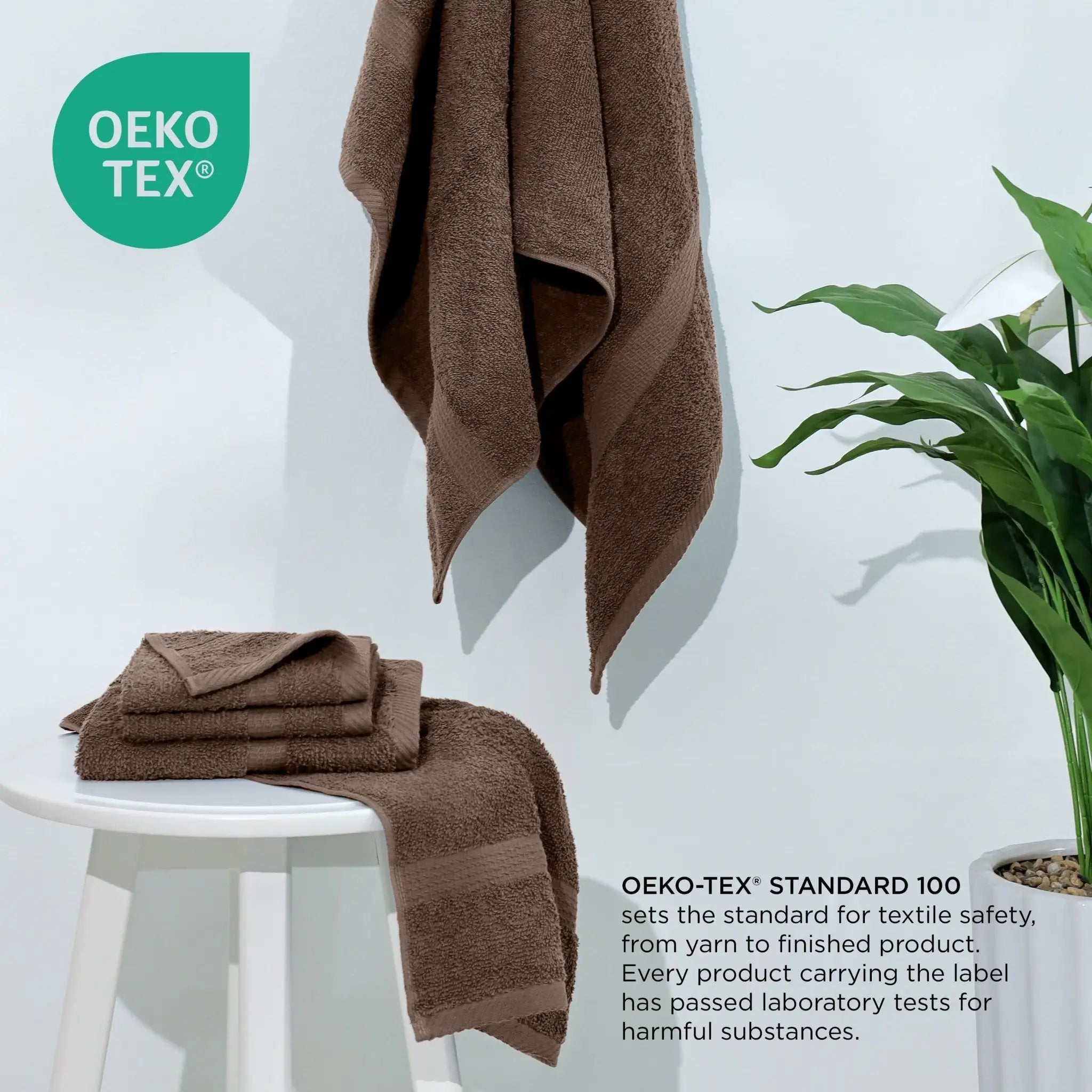 Brown towels on a white chair with Oeko-Tex logo and text.