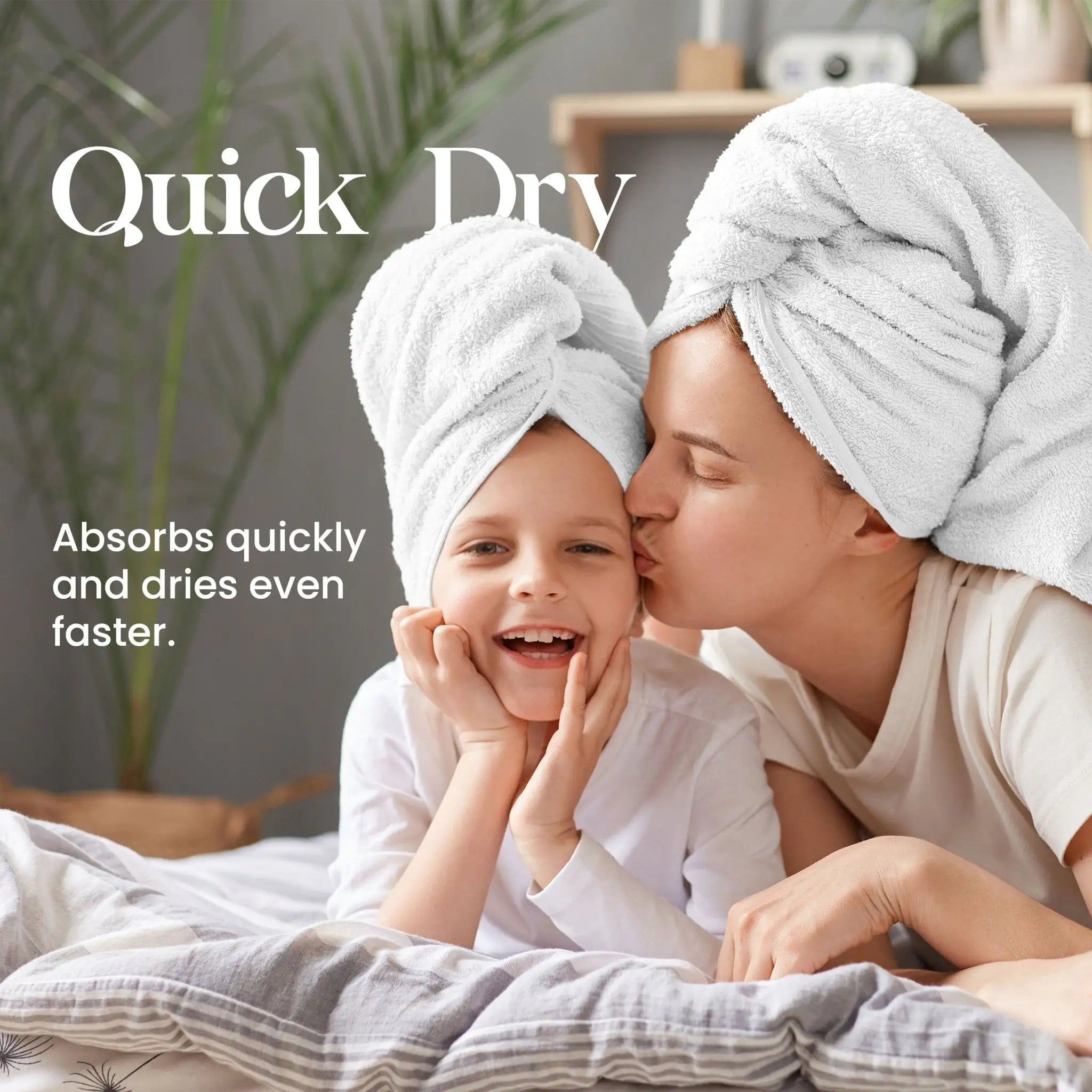 Mother and child with white towels on heads in a bathroom setting, promoting quick-drying towels.
