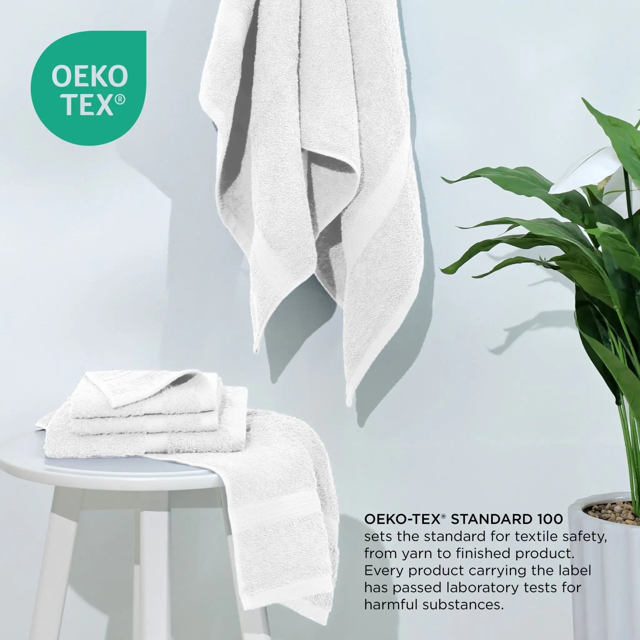 White towels with OEKO-TEX certification text and logo on a light gray background.
