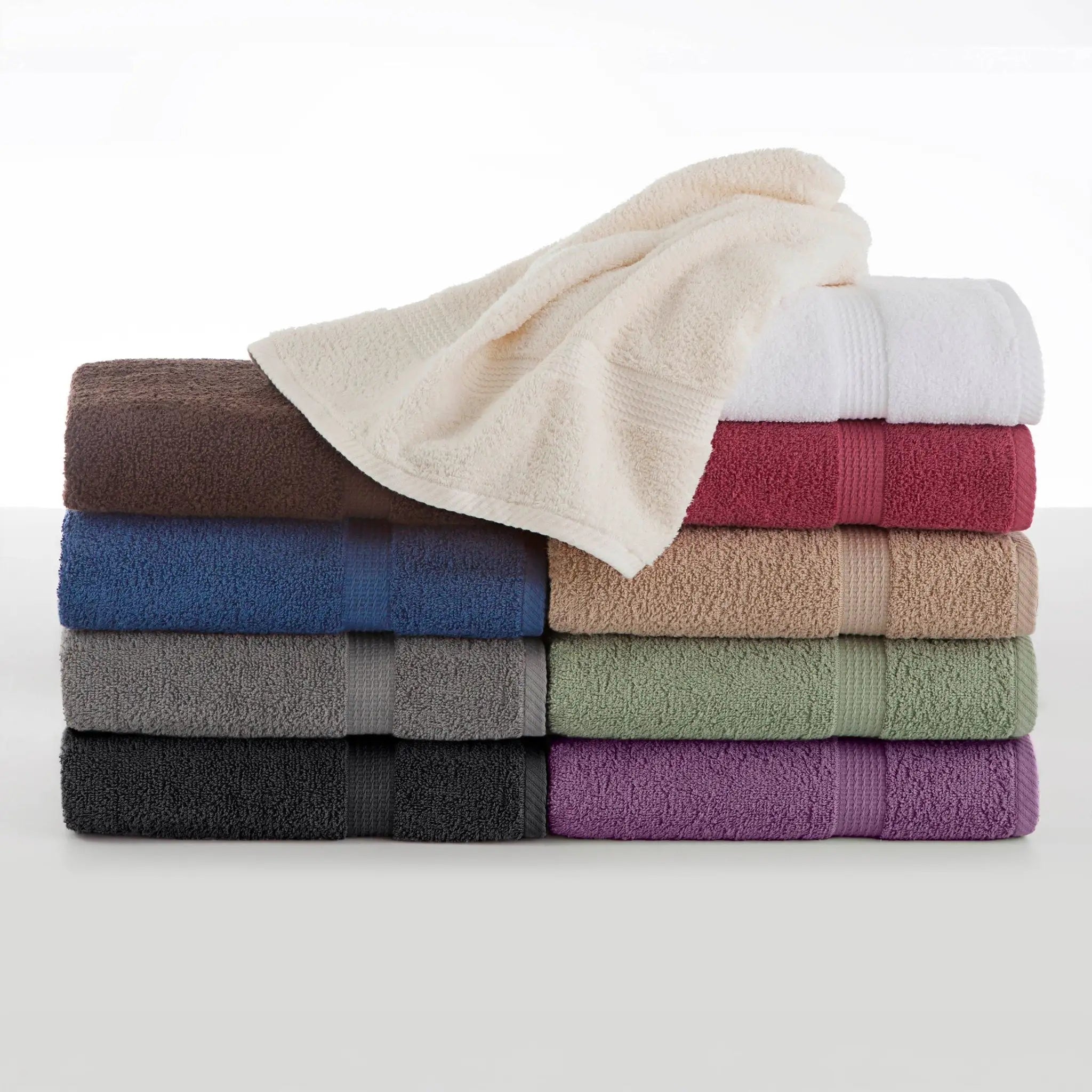 Stack of folded towels in various colors on a white background