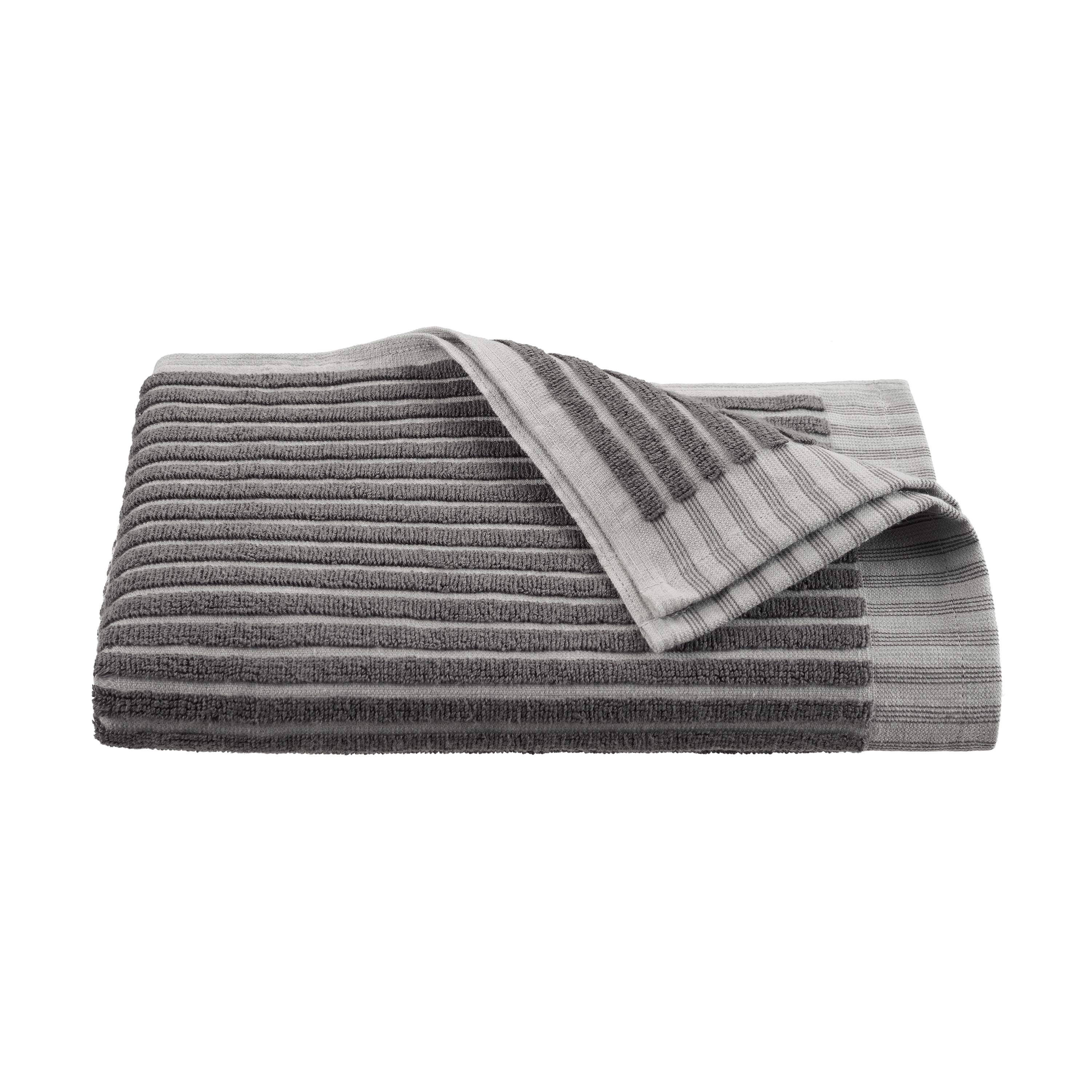 Gray towel with sculpted stripe design, folded with one corner partially turned down.