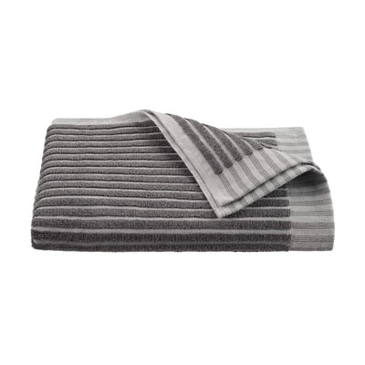 Gray towel with sculpted stripe design, folded with one corner partially turned down.