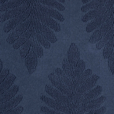 Dark blue bath rug featuring a textured fern ogee pattern.