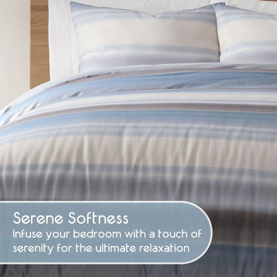 Striped comforter bedding set with pillow shams on a bed, featuring text about serene softness.