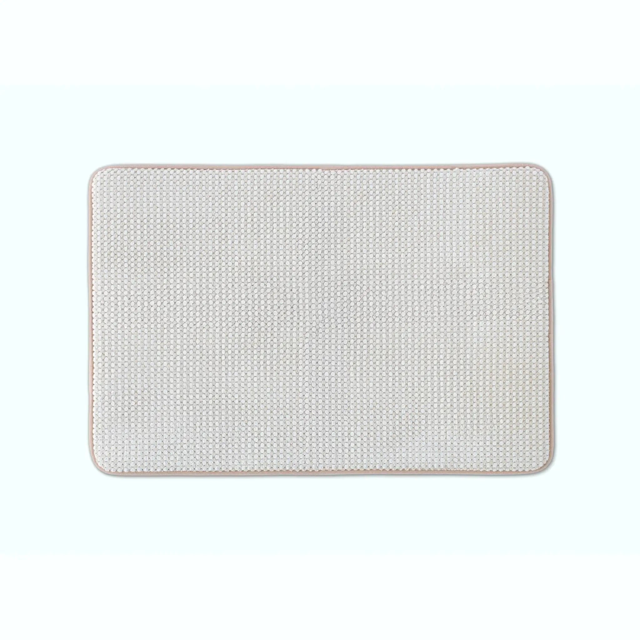 Sand color bath rug with rounded corners, shown flat against a solid white background.
