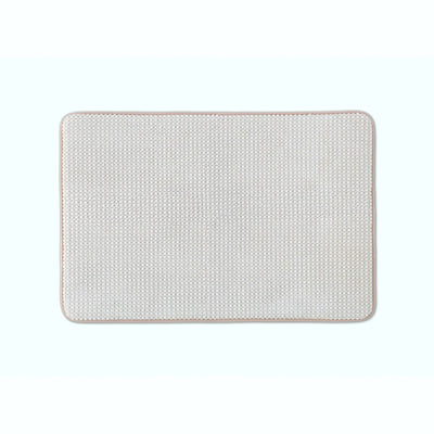 Sand color bath rug with rounded corners, shown flat against a solid white background.