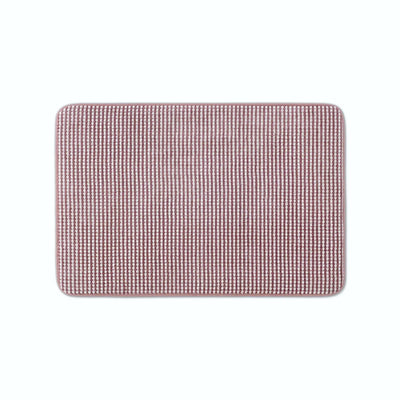 A rectangular berry color bath rug with rounded corners.