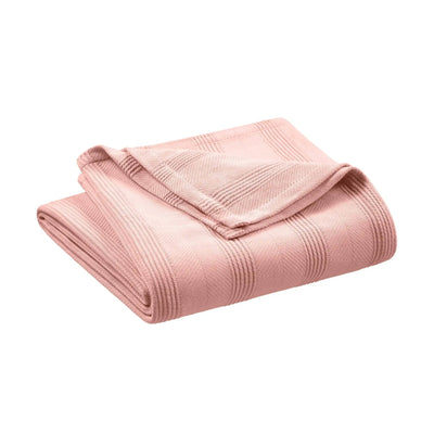Folded pink blanket on a white background