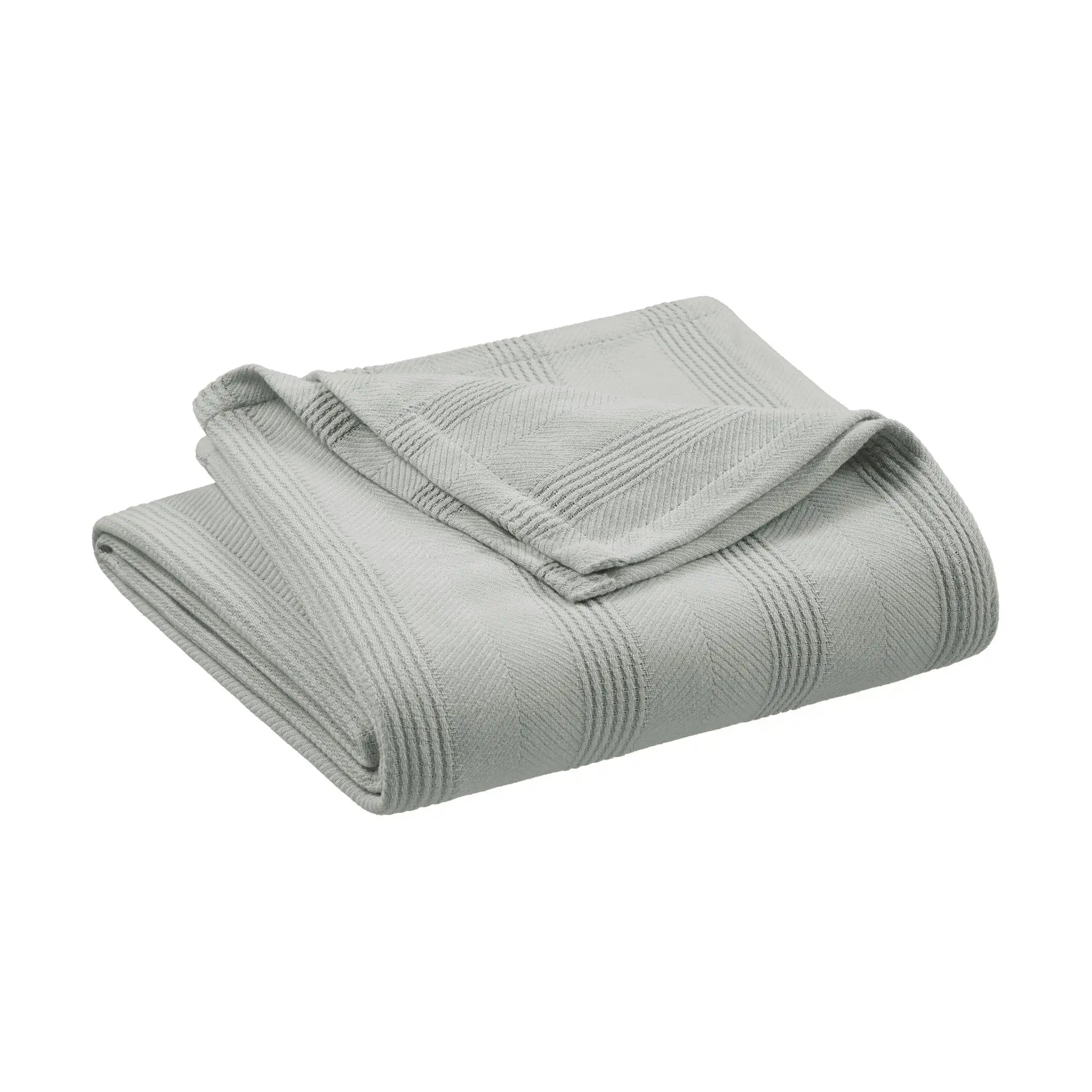 A folded light gray blanket with a textured, ribbed pattern, shown on a plain white background.