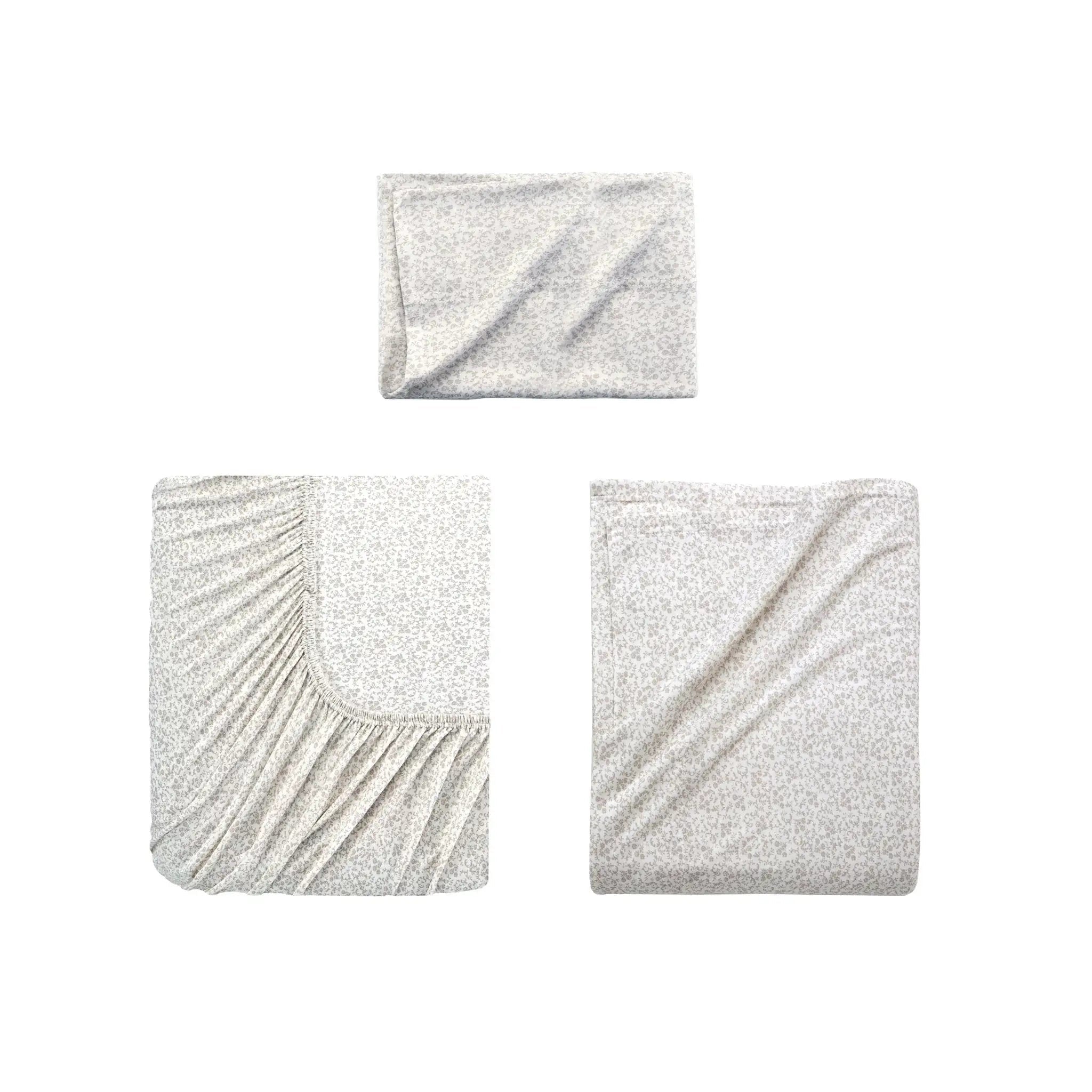 Three folded light gray textured fabric pieces, arranged on a plain white background.
