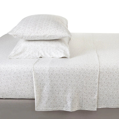 White textured bed sheet set with matching pillowcases on a bed.