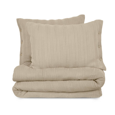 Folded beige textured blanket set on a white background