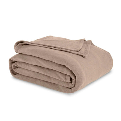 Folded beige blanket on a white background