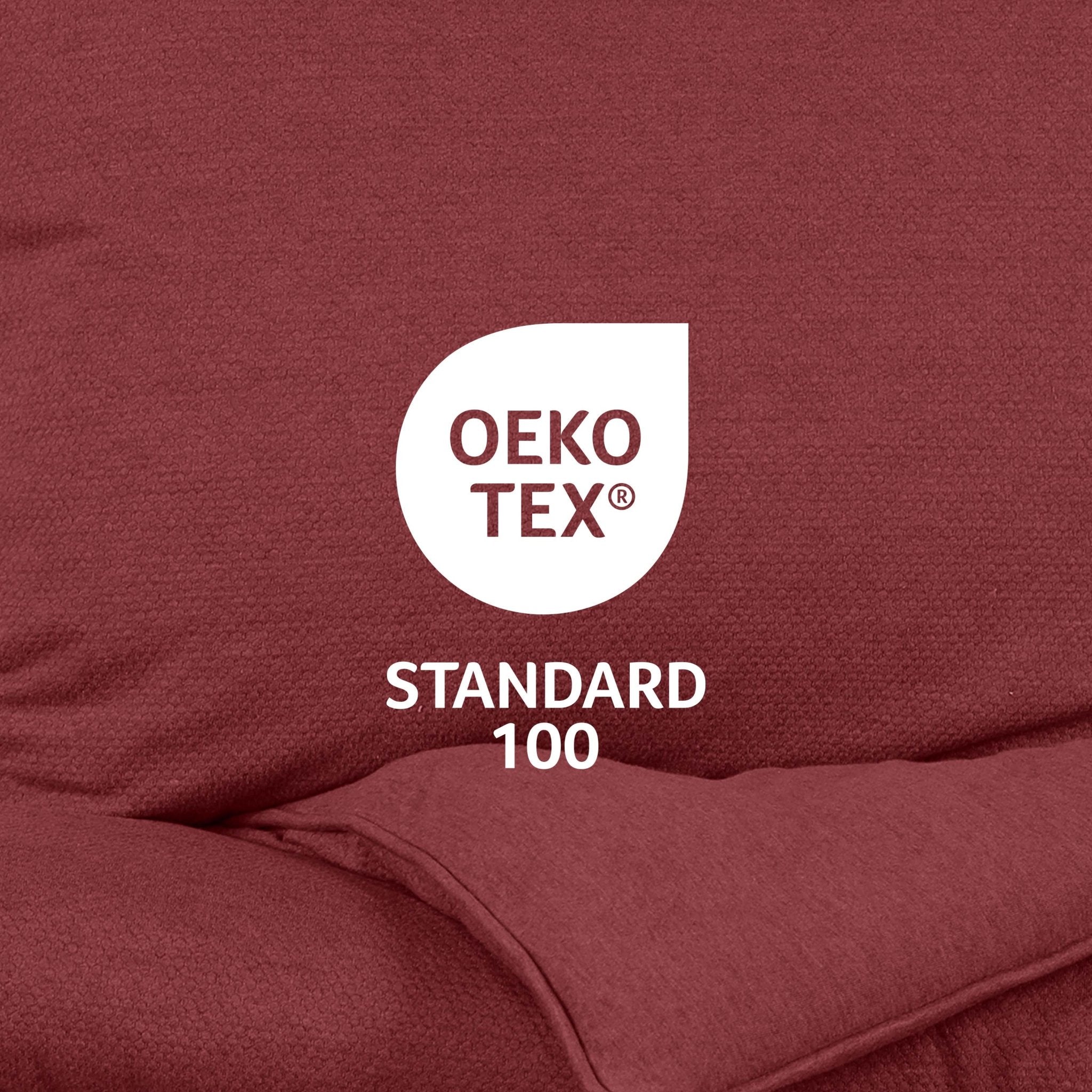 OEKO-TEX Standard 100 logo on a maroon fabric background