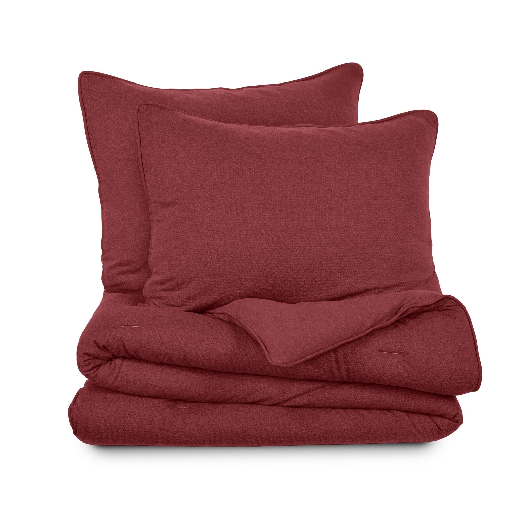 Red comforter set with two pillow shams on a white background