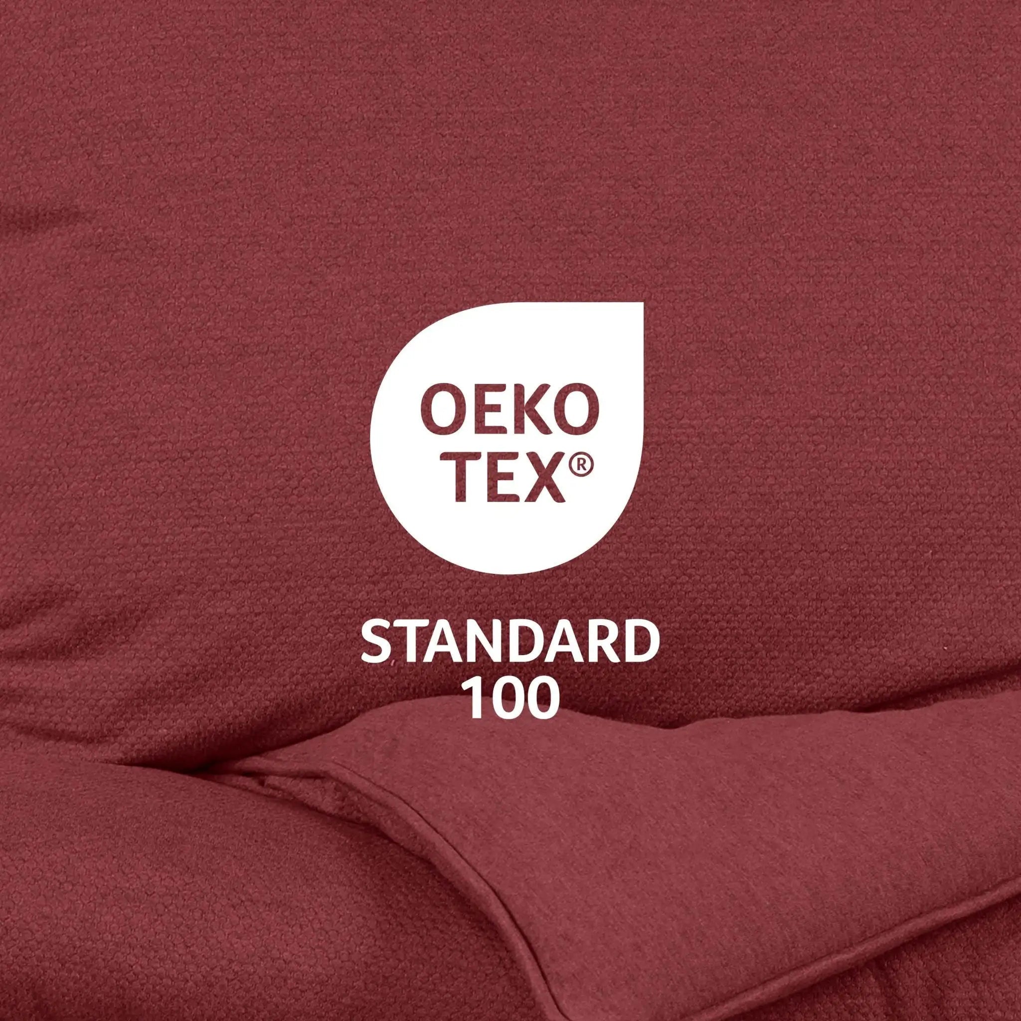 OEKO-TEX Standard 100 logo on a red fabric background