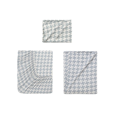 Three folded sheets with a light blue and white houndstooth pattern arranged on a plain white background.