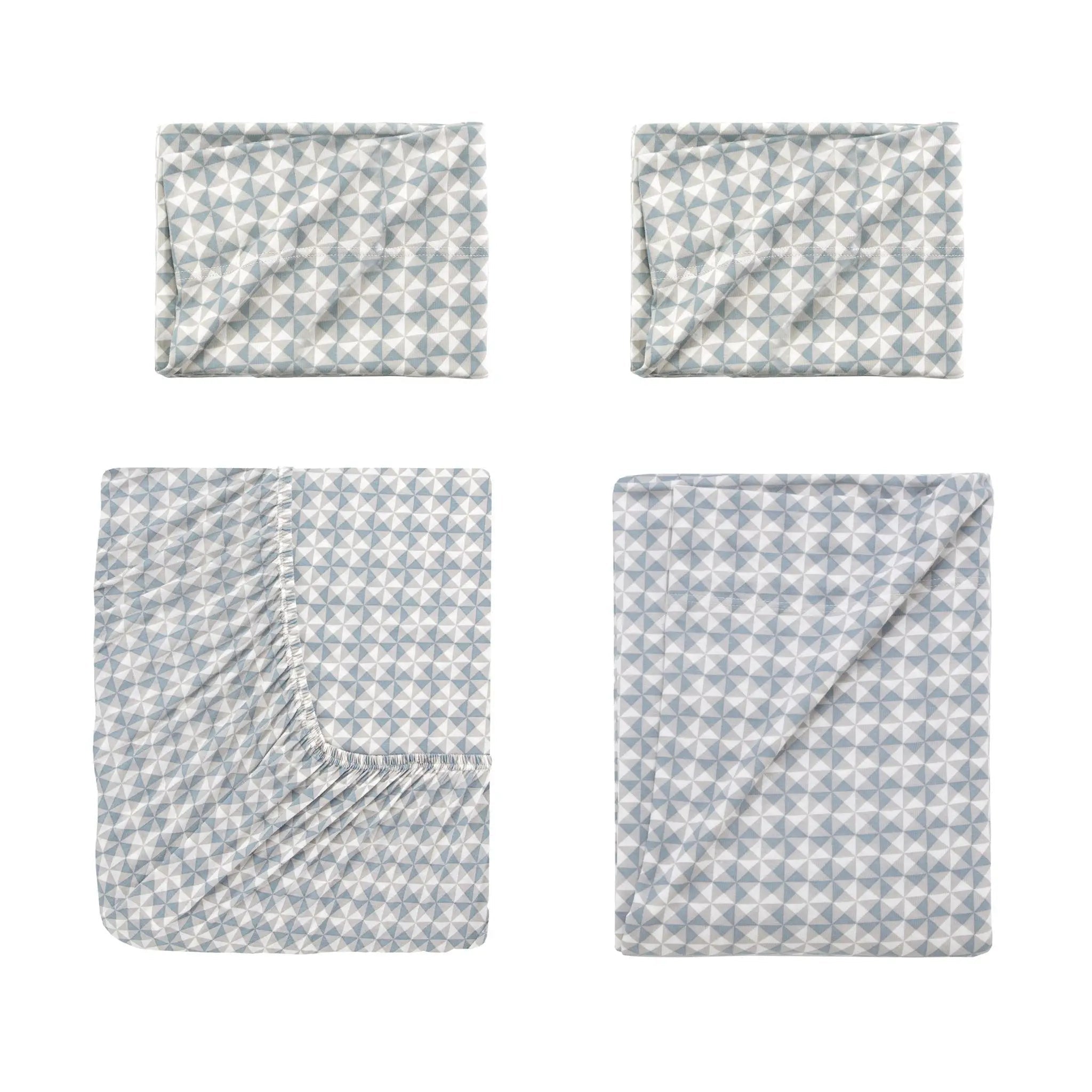 Four folded sheets with a light blue and white geometric star pattern arranged in a 2x2 grid on a white background.