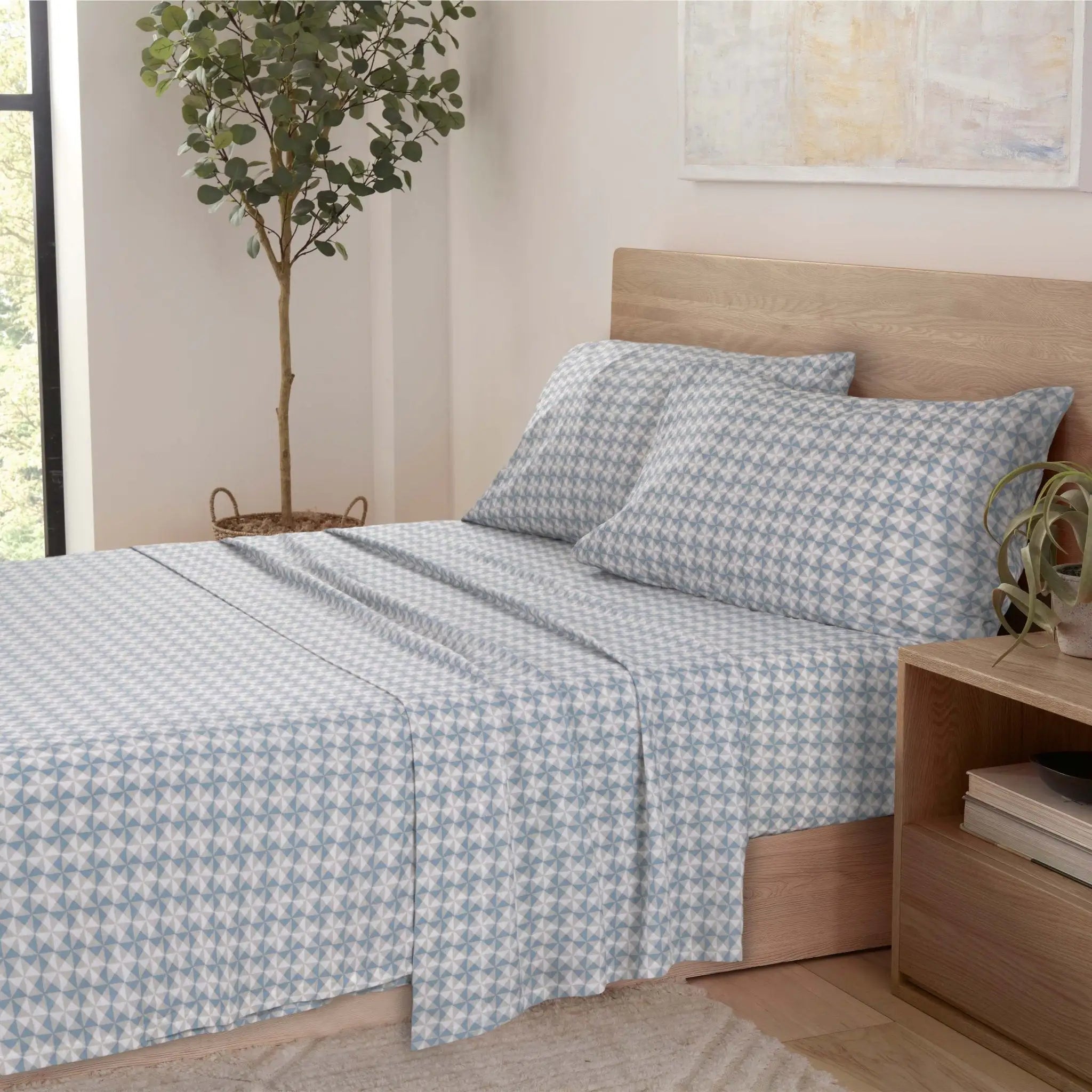 Bedroom with a bed featuring blue and white checkered bedding.