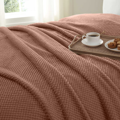 Copper blanket draped over a surface 
