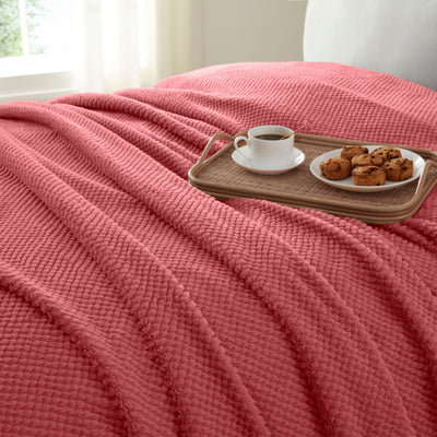 Deep Rose blanket draped over a surface 