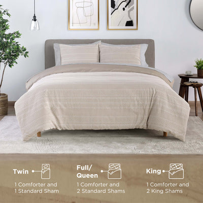 Beige comforter set on a bed in a bedroom with size indicators below.
