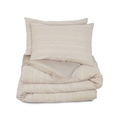 Beige textured comforter set on a white background
