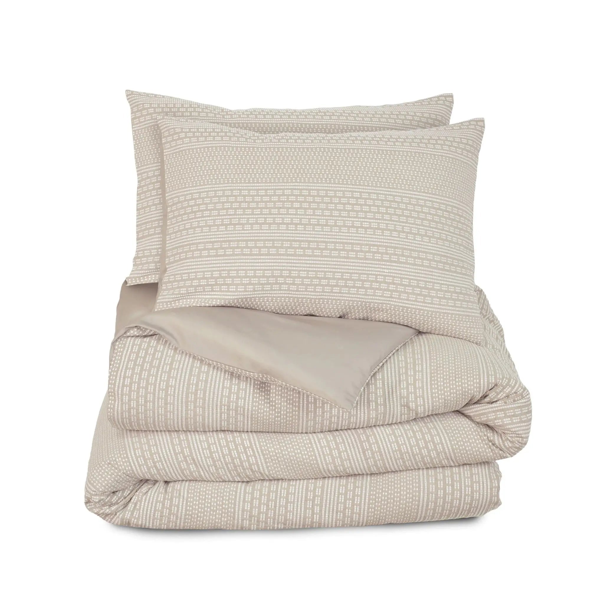 A folded beige comforter set, shown on a solid white background.