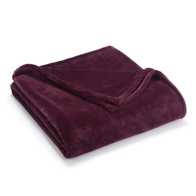 Folded fig colored blanket on a white background