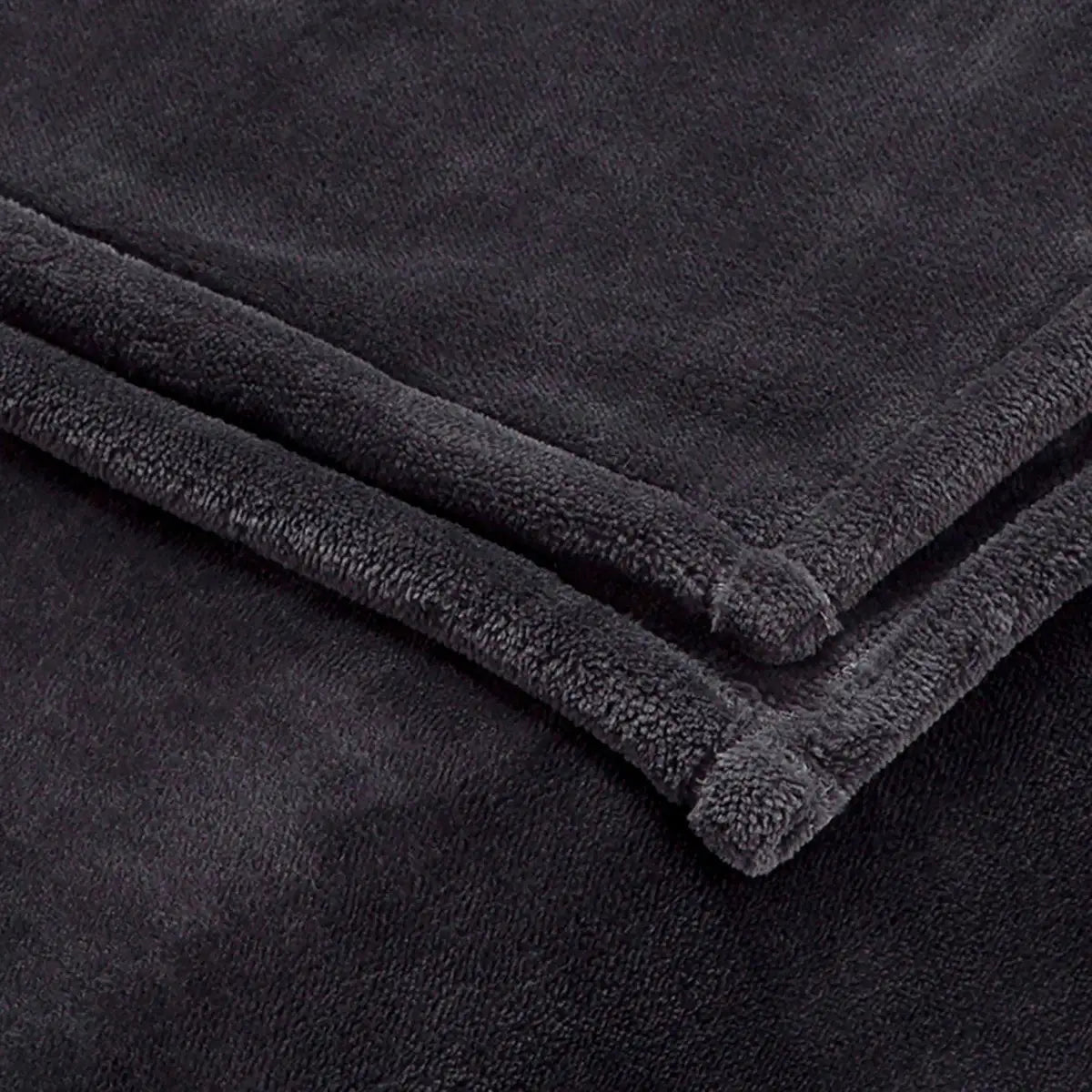 A close-up of a charcoal plush fleece blanket, folded to show its soft, textured terry fabric and stitched edges.