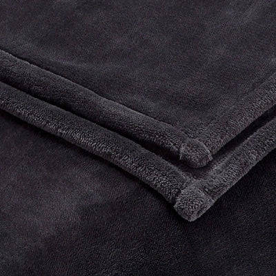 A close-up of a charcoal plush fleece blanket, folded to show its soft, textured terry fabric and stitched edges.