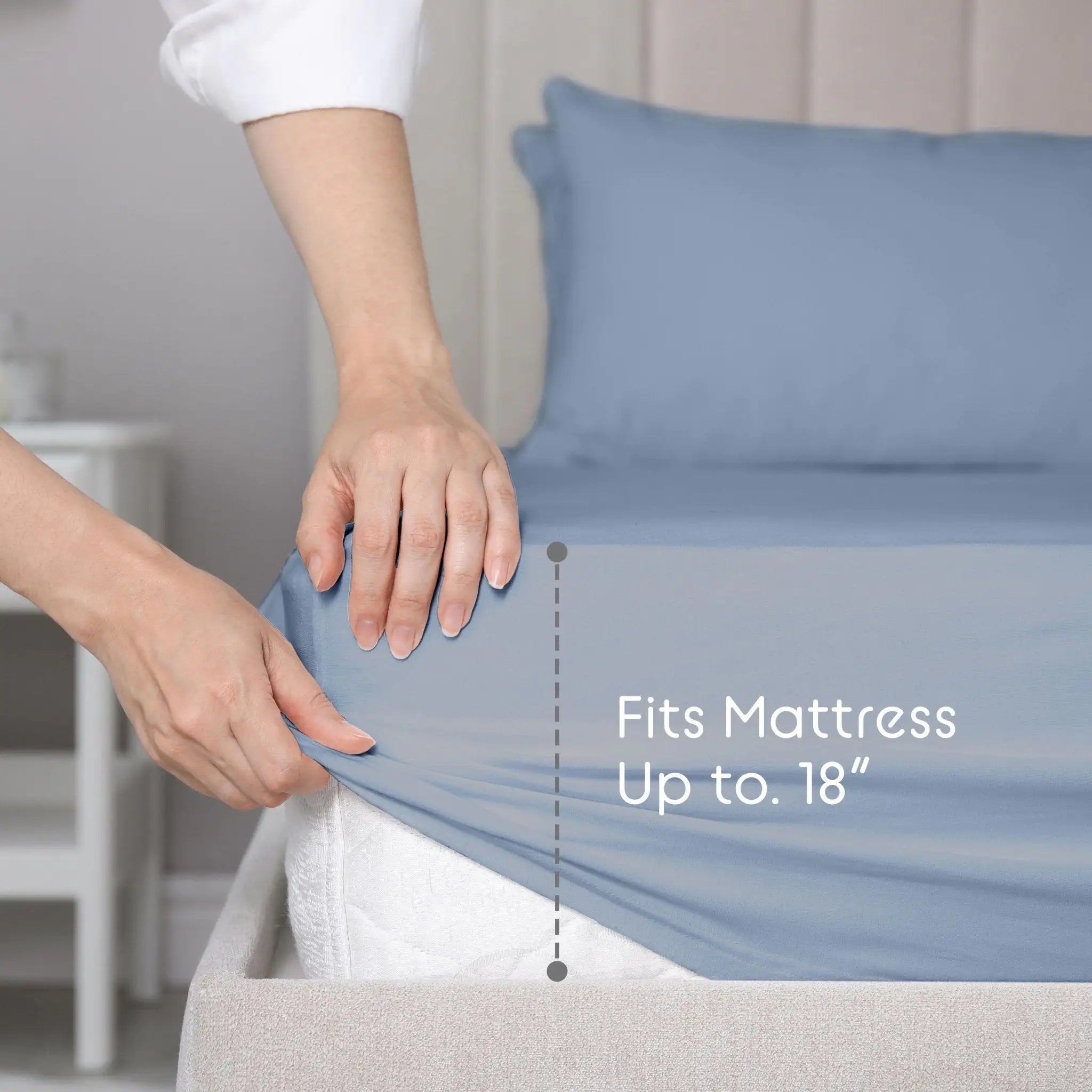 Person adjusting a fitted sheet on a bed with text indicating mattress size compatibility.