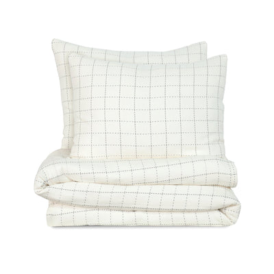 Ivory quilted coverlet set on a white background