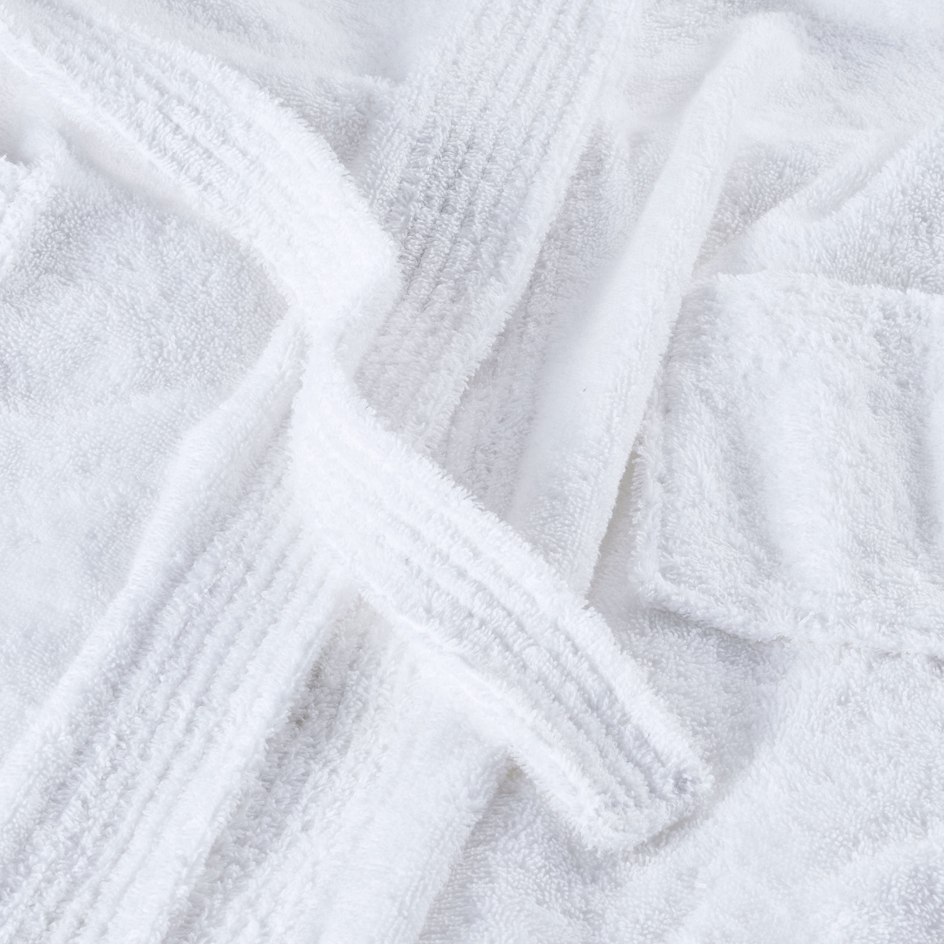 White hooded bath robe with textured fabric and tied belt.