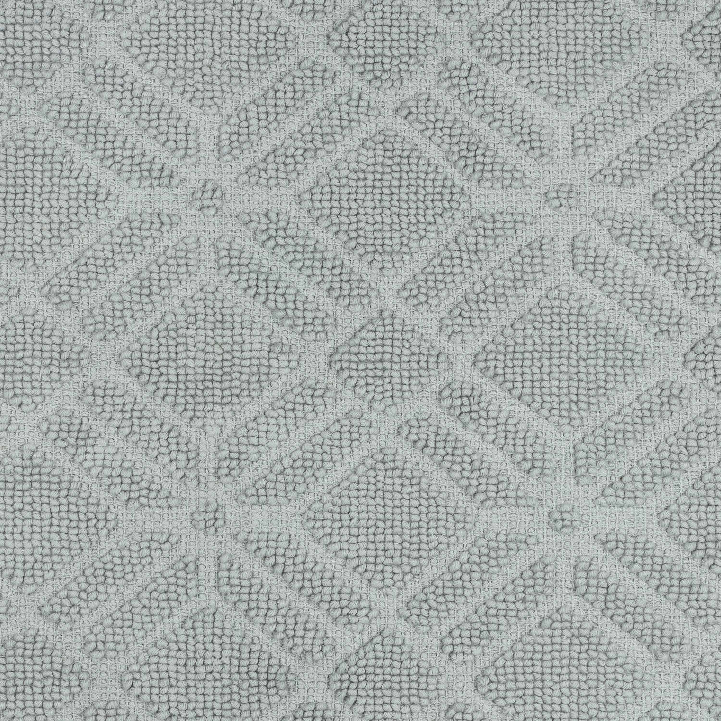 Textured bath rug featuring a geometric diamond pattern in light gray.