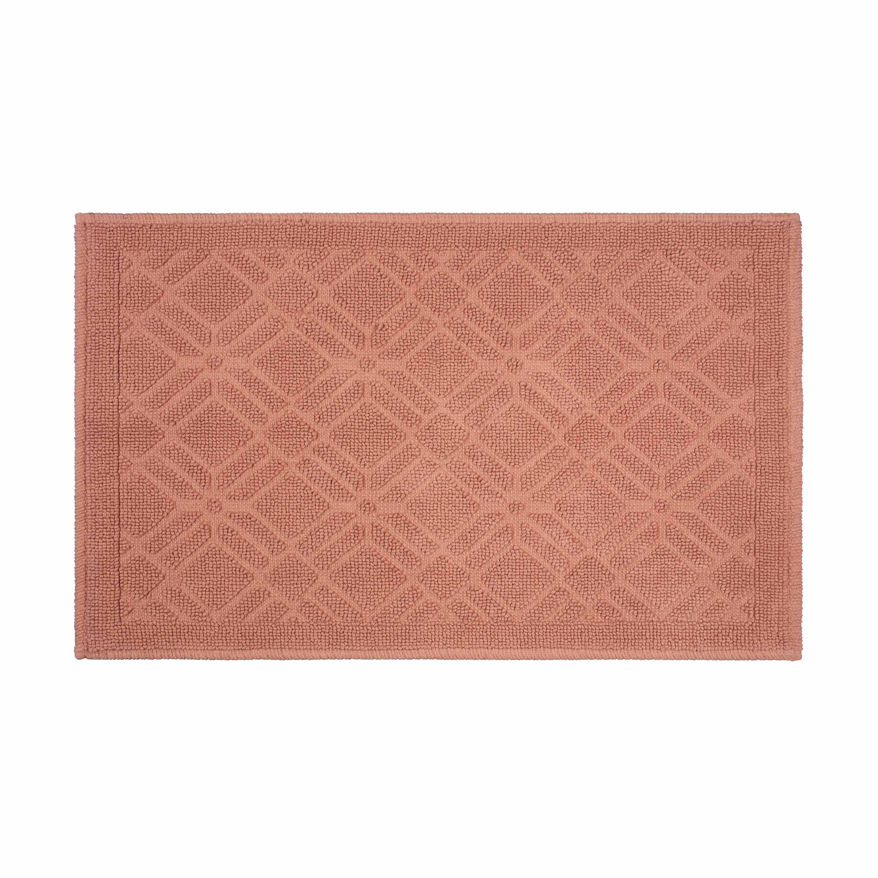 Rectangular bath rug in a soft coral color with a geometric pattern and a textured surface.