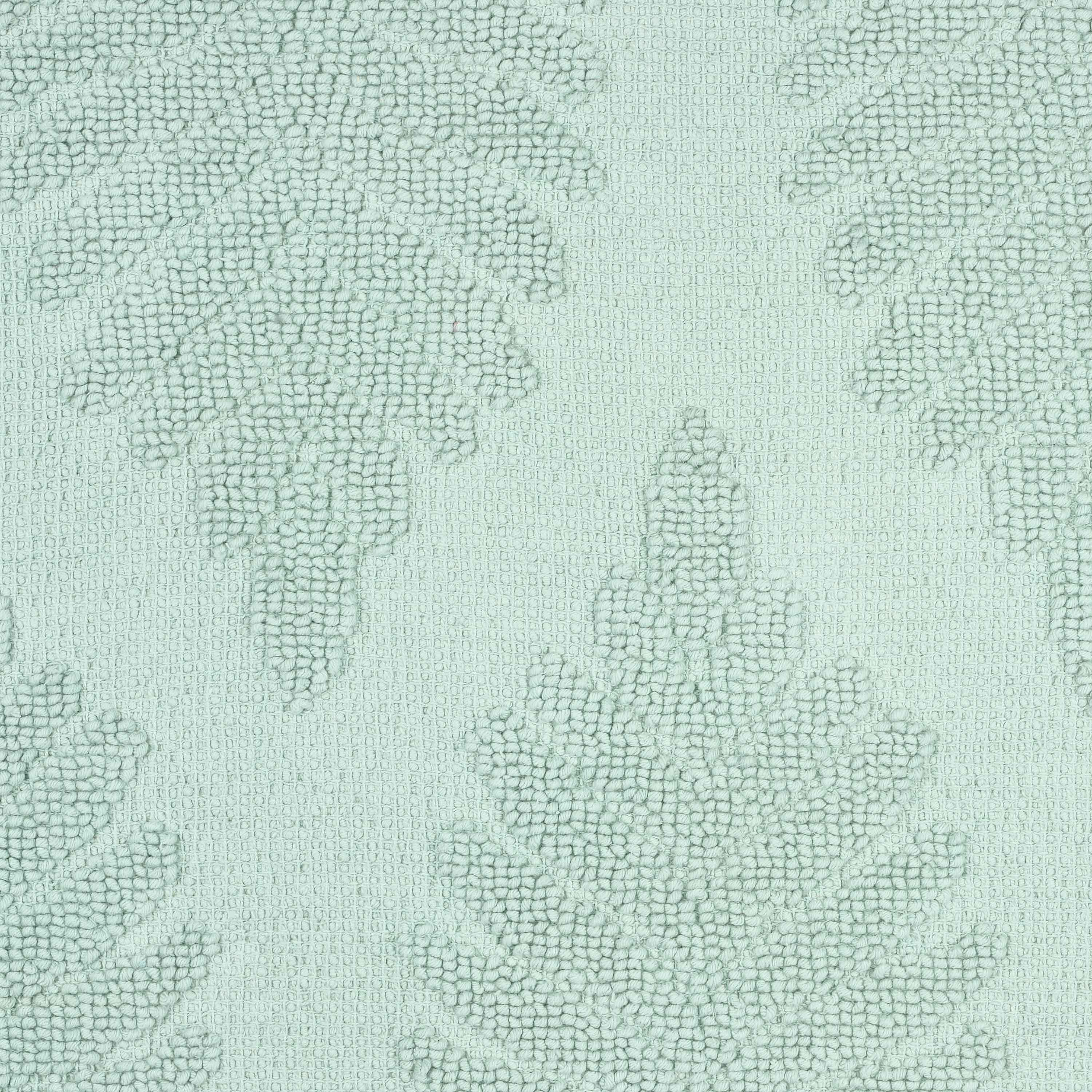 Light green bath rug featuring a textured fern ogee pattern.