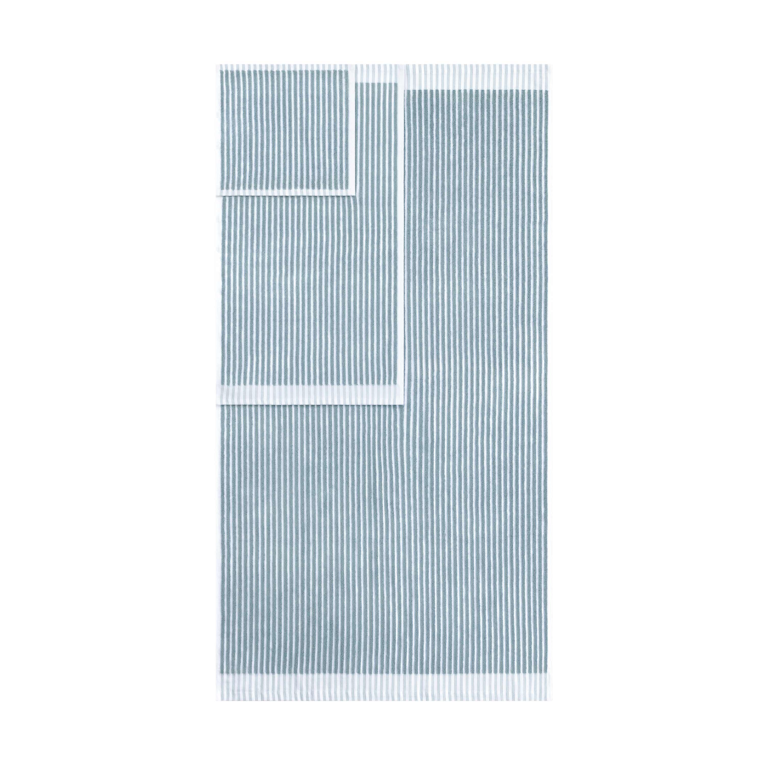 Two towels in a sculpted stripe design, featuring alternating light and dark blue stripes with white borders.