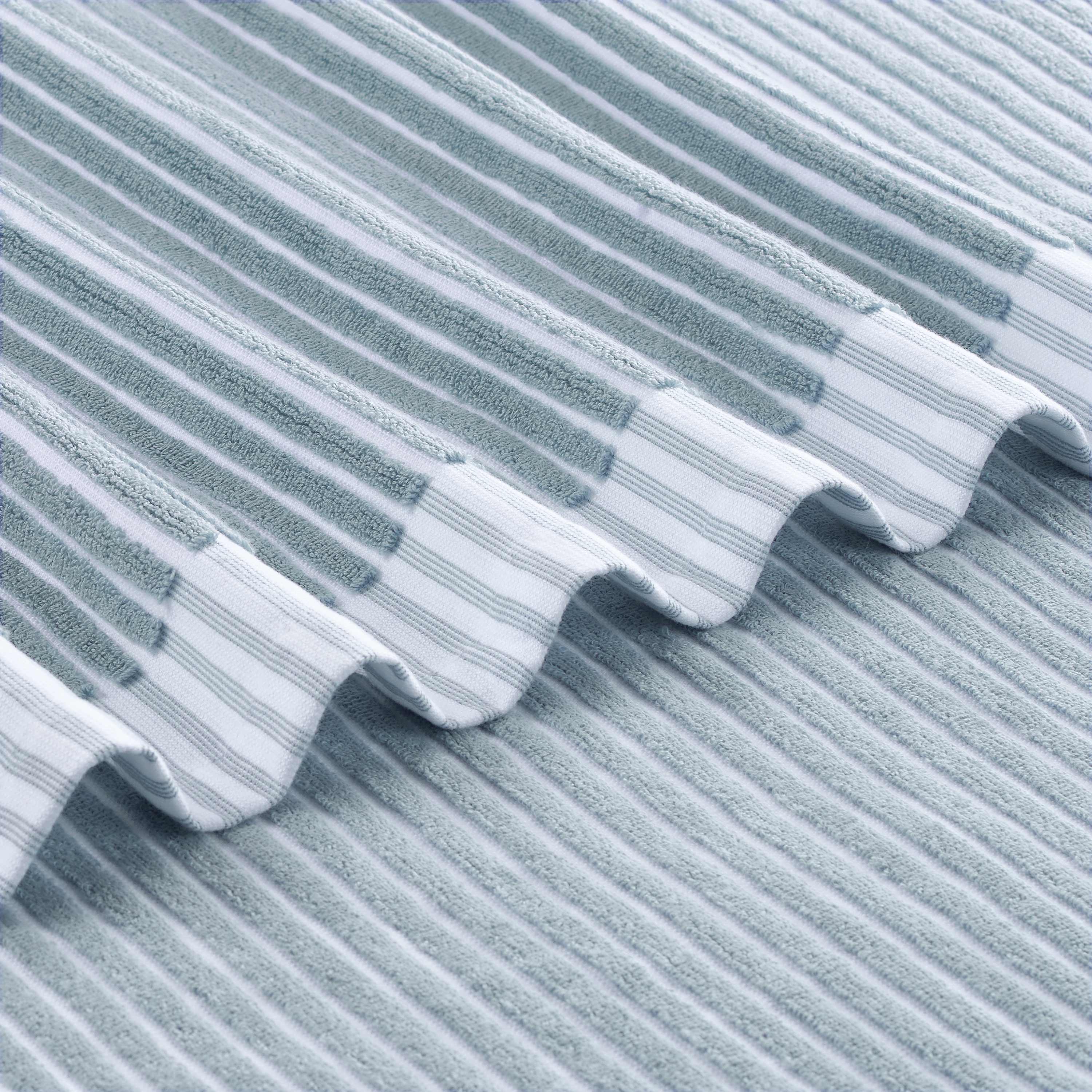 Textured towel featuring alternating sculpted stripes in light blue and white.