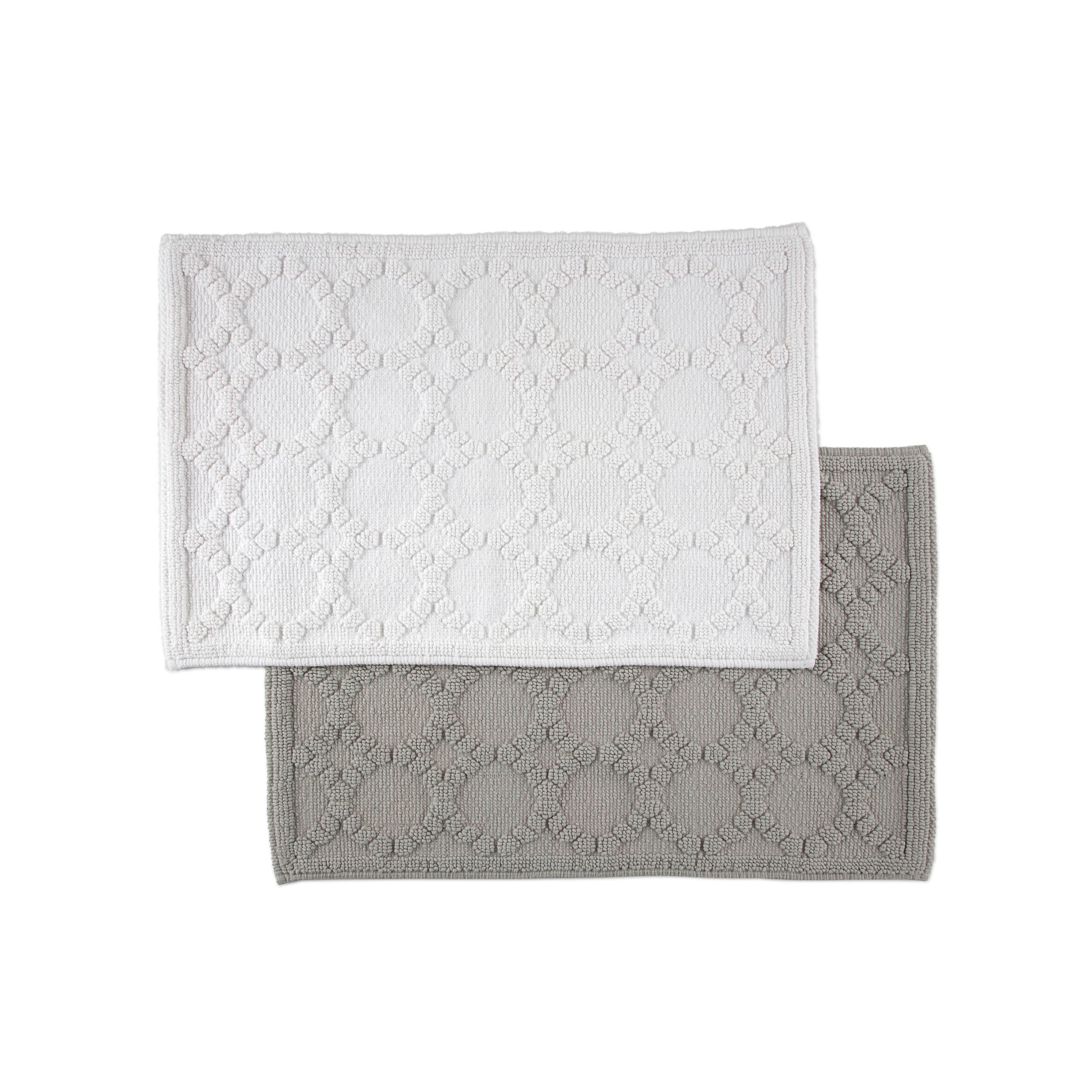 Two rectangular bath rugs in white and gray with a textured circular pattern.