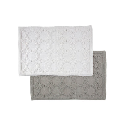 Two rectangular bath rugs in white and gray with a textured circular pattern.