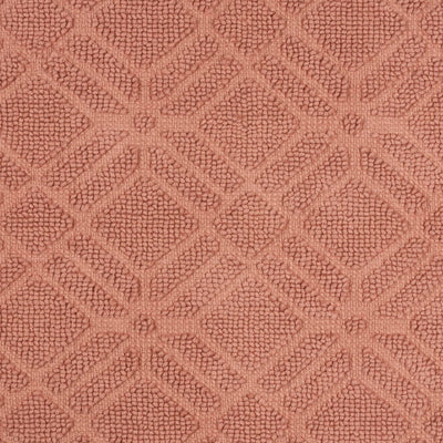 Textured bath rug in a geometric diamond pattern, featuring a soft, muted pink color.