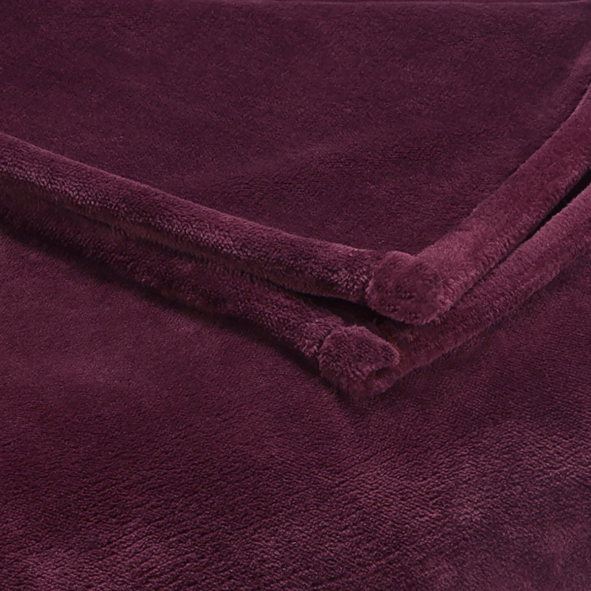 Deep purple sheared faux mink blanket with soft texture and rolled edges.